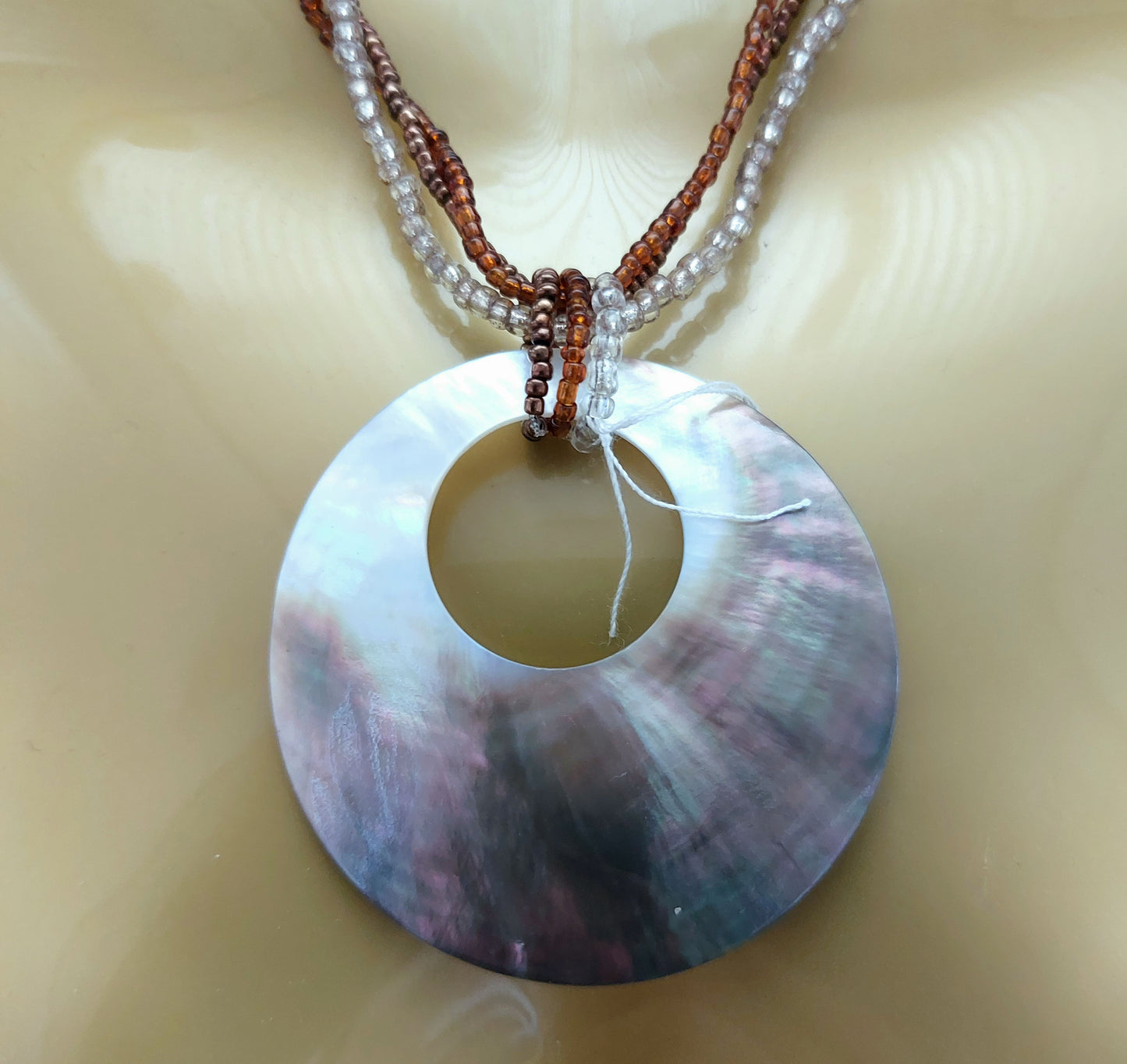 MOTHER OF PEARL CIRCLE PENDANT ON BEADED NECKLACE